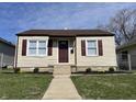 Charming home featuring a well-manicured lawn, vinyl siding, and delightful curb appeal at 1612 E Raymond St, Indianapolis, IN 46203
