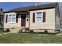 Charming home featuring a well-manicured lawn, vinyl siding, and delightful curb appeal at 1612 E Raymond St, Indianapolis, IN 46203