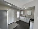 Modern kitchen featuring stainless steel appliances, white cabinets, and a stylish floor at 1612 E Raymond St, Indianapolis, IN 46203