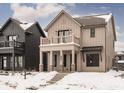 Two-story farmhouse-style home with balcony, brick accents, and snow-covered landscaping at 17363 Newton Main St, Westfield, IN 46074