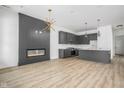 Modern kitchen with gray cabinetry, quartz countertops, and a built-in fireplace at 17363 Newton Main St, Westfield, IN 46074