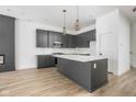 Modern kitchen with gray island, quartz countertops and gold fixtures at 17363 Newton Main St, Westfield, IN 46074
