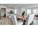 Open concept kitchen with white cabinets, island, and hardwood floors at 2378 Dixon Creek Dr, Whitestown, IN 46075