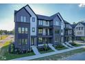 Modern townhomes featuring brick and gray siding, black trim, and newly landscaped front yards at 373 S Cherry St, Westfield, IN 46074
