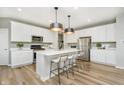 Modern kitchen with white cabinets, stainless steel appliances, and an island at 6879 Seabiscuit Rd, Whitestown, IN 46075