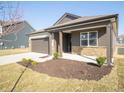 Attractive single-Gathering home featuring a covered porch, two-car garage, and well-maintained landscaping at 9236 Kavanaugh Dr, Indianapolis, IN 46239