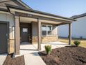 Inviting covered porch with stone accents, providing a cozy entrance to this charming home at 9236 Kavanaugh Dr, Indianapolis, IN 46239