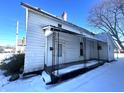 White house exterior with front porch, snow on the ground at 1125 Laurel St, Indianapolis, IN 46203