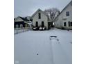 House exterior with snowy front yard and white picket fence at 1125 Laurel St, Indianapolis, IN 46203