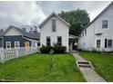 Charming two-story home with landscaped yard and inviting walkway to a cozy front porch at 1125 Laurel St, Indianapolis, IN 46203