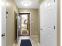 Welcoming entryway showcases tile flooring and a view of the home's exterior at 13494 Forum Meadows Dr, Carmel, IN 46033