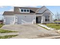 Two story home with gray brick and three car garage at 17105 Silo Ridge Way, Noblesville, IN 46060