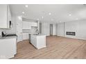 Open concept kitchen features island, stainless steel appliances, and white cabinetry at 17105 Silo Ridge Way, Noblesville, IN 46060