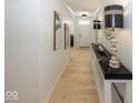 Bright and airy hallway with hardwood floors and modern light fixtures at 19046 Beverly Shones Ln, Noblesville, IN 46062