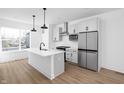 Modern kitchen with island, stainless steel appliances, and white cabinets at 2145 N College Ave, Indianapolis, IN 46202