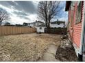 Fenced backyard with a grassy area and a fire pit at 2607 E 12Th St, Indianapolis, IN 46201