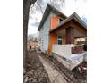 Side view of the house, showcasing the orange and light blue paint at 2607 E 12Th St, Indianapolis, IN 46201
