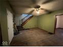 Living room with hardwood floors, a staircase, and green walls at 2607 E 12Th St, Indianapolis, IN 46201