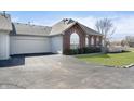 The house has an attached garage, brick accents, and a paved driveway at 2811 Grandview Ln, Greenwood, IN 46143