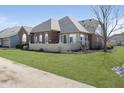 Lovely brick house showcasing well-kept landscaping, white picket fence, and great natural light at 2811 Grandview Ln, Greenwood, IN 46143