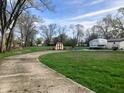 Spacious backyard showcasing a shed and camper with ample green space at 2920 Newhart St, Indianapolis, IN 46217