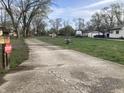 Long driveway leading to a home with additional buildings, offering ample space and parking at 2920 Newhart St, Indianapolis, IN 46217