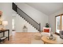 Bright living room with hardwood floors, modern staircase, and comfy seating at 3764 Glenwood Dr, Martinsville, IN 46151