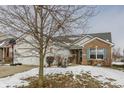 Ranch home with attached garage, snow-covered lawn, and basketball hoop at 3865 Dusty Sands Rd, Whitestown, IN 46075