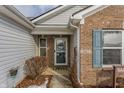 Front entrance with brick facade, teal shutters, and a welcoming mat at 3865 Dusty Sands Rd, Whitestown, IN 46075