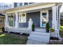 Inviting front porch with classic columns, fresh flowers, and manicured landscaping at 404 N Gray St, Indianapolis, IN 46201