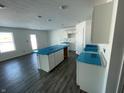 Spacious kitchen boasting white cabinets and gray vinyl plank flooring at 6630 Sulgrove Pl, Indianapolis, IN 46221