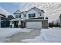 Two-story home with white siding, brick accents, and a two-car garage at 6823 Aster Dr, Pendleton, IN 46064