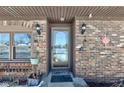Brick front entrance with glass door and sconces at 6932 W Jennifer Ln, Greenfield, IN 46140