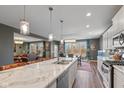 Spacious kitchen features a center island, stainless steel appliances, and an open floor plan at 7414 Glen Park Way, Indianapolis, IN 46259
