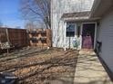 A fenced backyard with a chair, privacy fence, and exterior access at 8023 Xenia Dr, Indianapolis, IN 46227