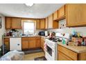 Small kitchen with wood cabinets and gas stove at 13346 N Miller Dr, Camby, IN 46113