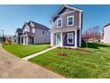 Well maintained lawn with a sidewalk leading to a charming two-story home at 1713 Real St, Indianapolis, IN 46240