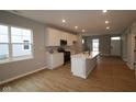 Modern kitchen features an island with quartz countertop and stainless steel appliances at 1713 Real St, Indianapolis, IN 46240