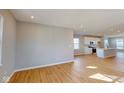 Bright and airy living room featuring beautiful hardwood floors that lead to the modern kitchen at 1713 Real St, Indianapolis, IN 46240