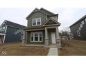 Charming two-story home featuring a covered entryway and craftsman-style architecture, great curb appeal at 1717 Real St, Indianapolis, IN 46240