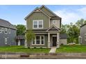 Charming two-story home featuring stone accents, well-kept lawn, and a welcoming front porch at 1717 Real St, Indianapolis, IN 46240