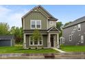 Charming two-story home featuring stone accents, well-kept lawn, and a welcoming front porch at 1717 Real St, Indianapolis, IN 46240