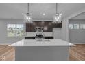 Modern kitchen with a large island, stainless steel appliances, and stylish pendant lighting at 1717 Real St, Indianapolis, IN 46240