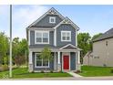 Charming two-story home with a red front door, gray siding, white trim, and manicured lawn at 1721 Real St, Indianapolis, IN 46240