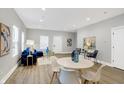 Open concept living and dining area with hardwood floors and stylish furniture at 2136 Sugar Grove Ave, Indianapolis, IN 46202