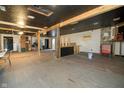 Unfinished interior space with exposed beams and partial bar at 3324 Prospect St, Indianapolis, IN 46203