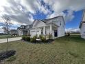Two-story house with gray siding, white trim, and a covered front porch at 3406 Preakness St, Whitestown, IN 46075