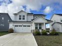 Two-story house with gray siding, white trim, and a two-car garage at 3406 Preakness St, Whitestown, IN 46075
