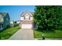 Charming two-story home with an attached two-car garage and large green tree at 3460 Limelight Ln, Whitestown, IN 46075