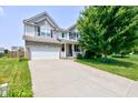 Charming two-story home featuring a two-car garage, a front porch, and beautiful landscaping at 3460 Limelight Ln, Whitestown, IN 46075